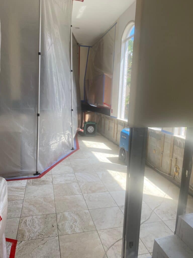 TLG Restoration containment work protecting a tiled hallway on a Palm Beach County job